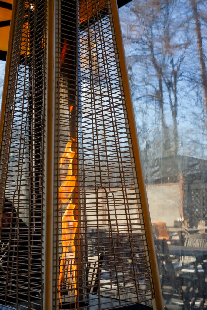 cafe terrace with tables and chairs with gas heater pyramid